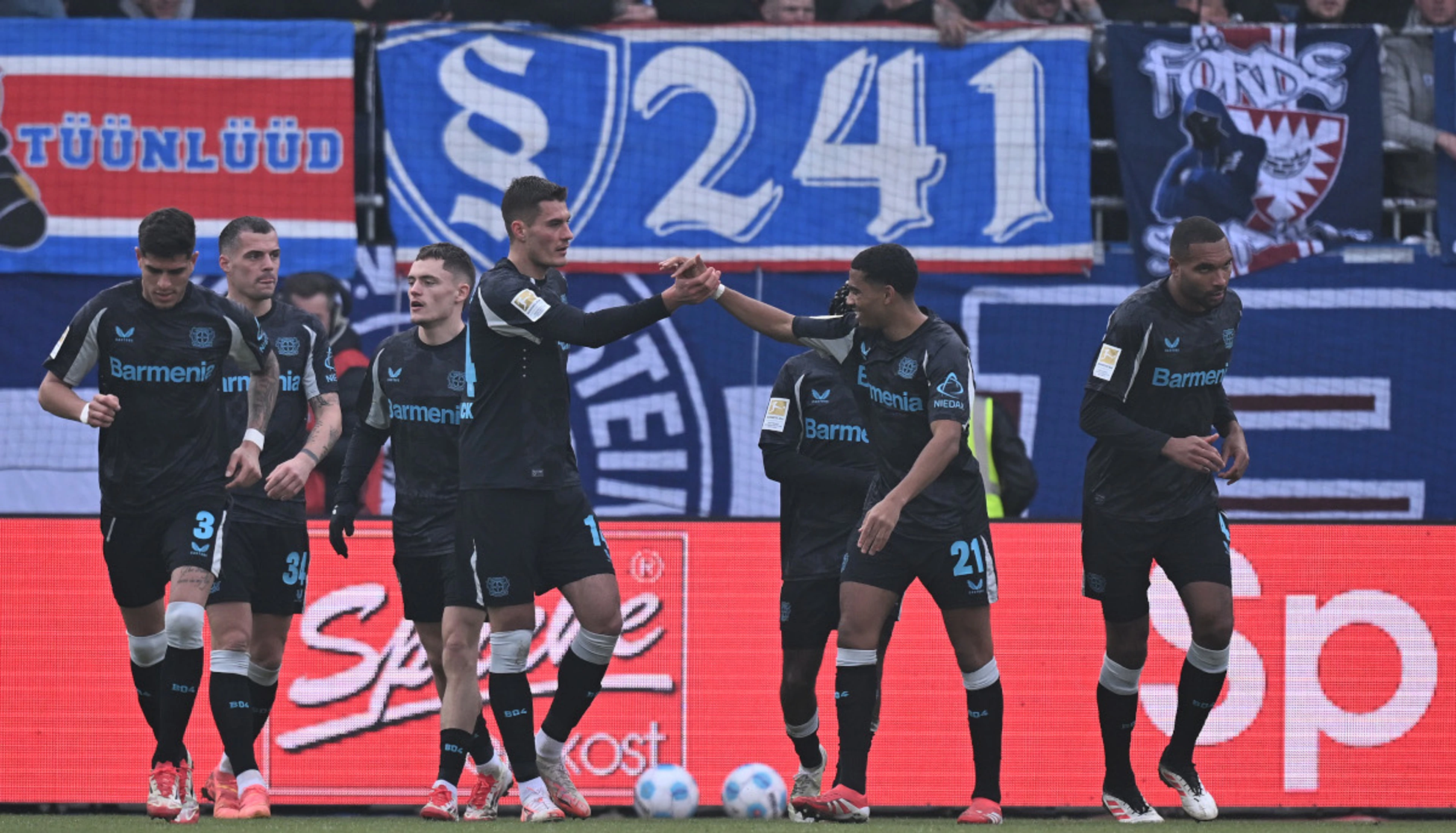 Leverkusen ease to victory at Kiel to trim Bayern lead