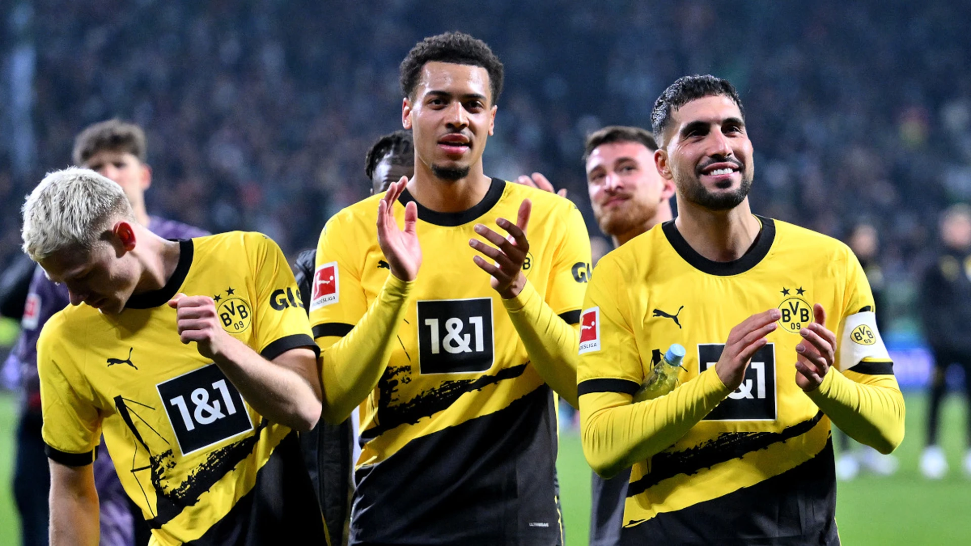 Ten-man Dortmund hold on to fourth spot with win at Werder Bremen