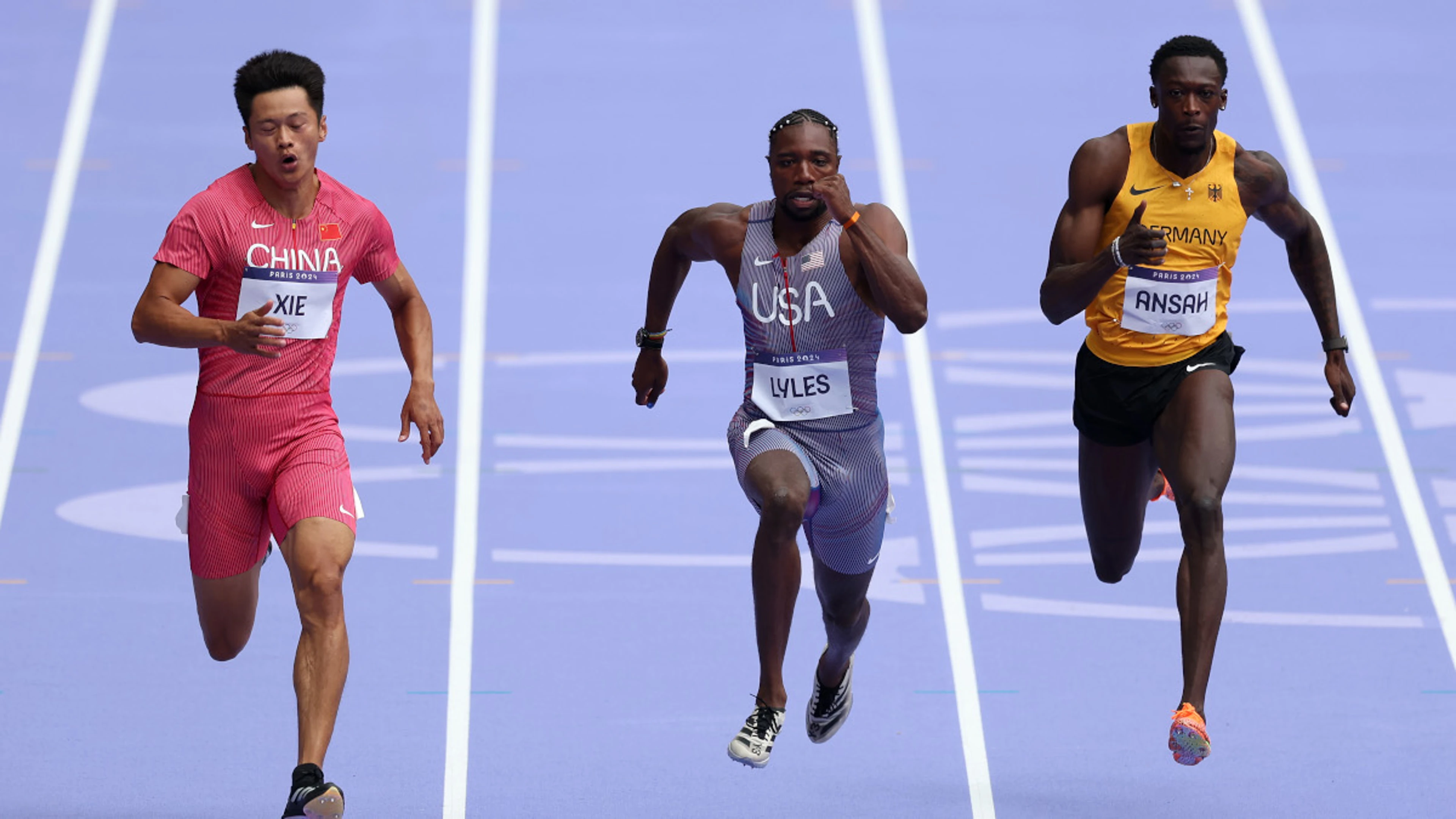 Lyles handed Olympic lesson, advances into 100m semis