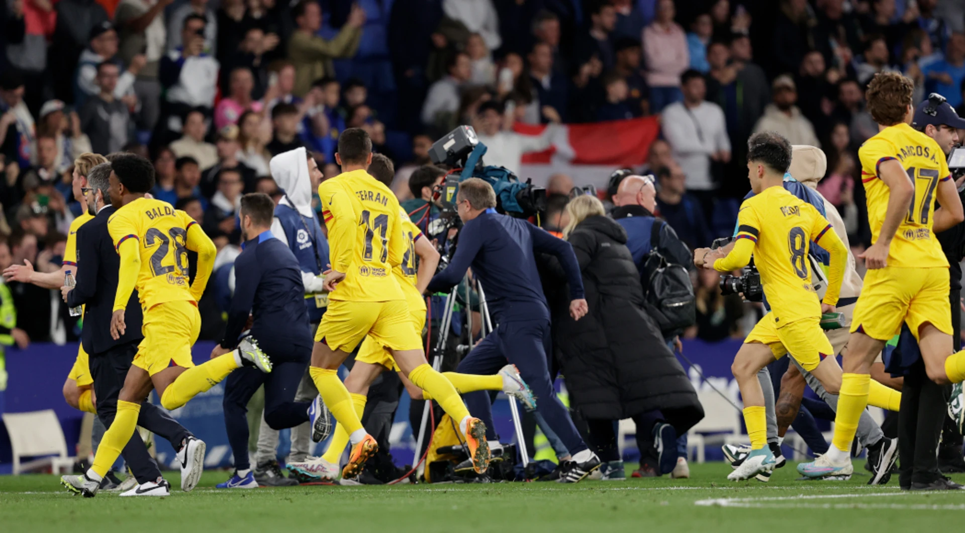 Triumphant Barca players chased from pitch by angry Espanyol fans