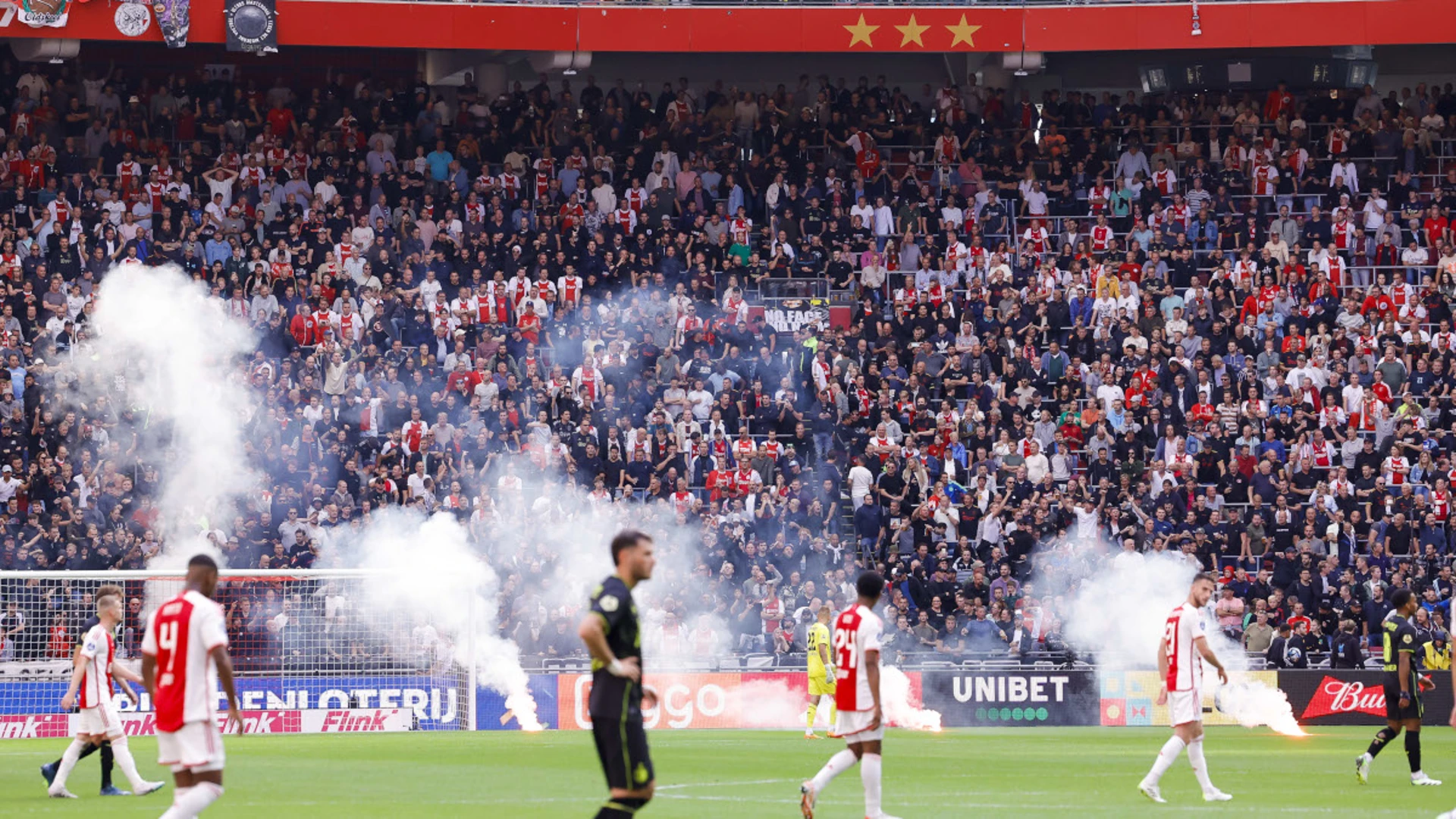 Ajax-Feyenoord abandoned after flares lobbed on pitch