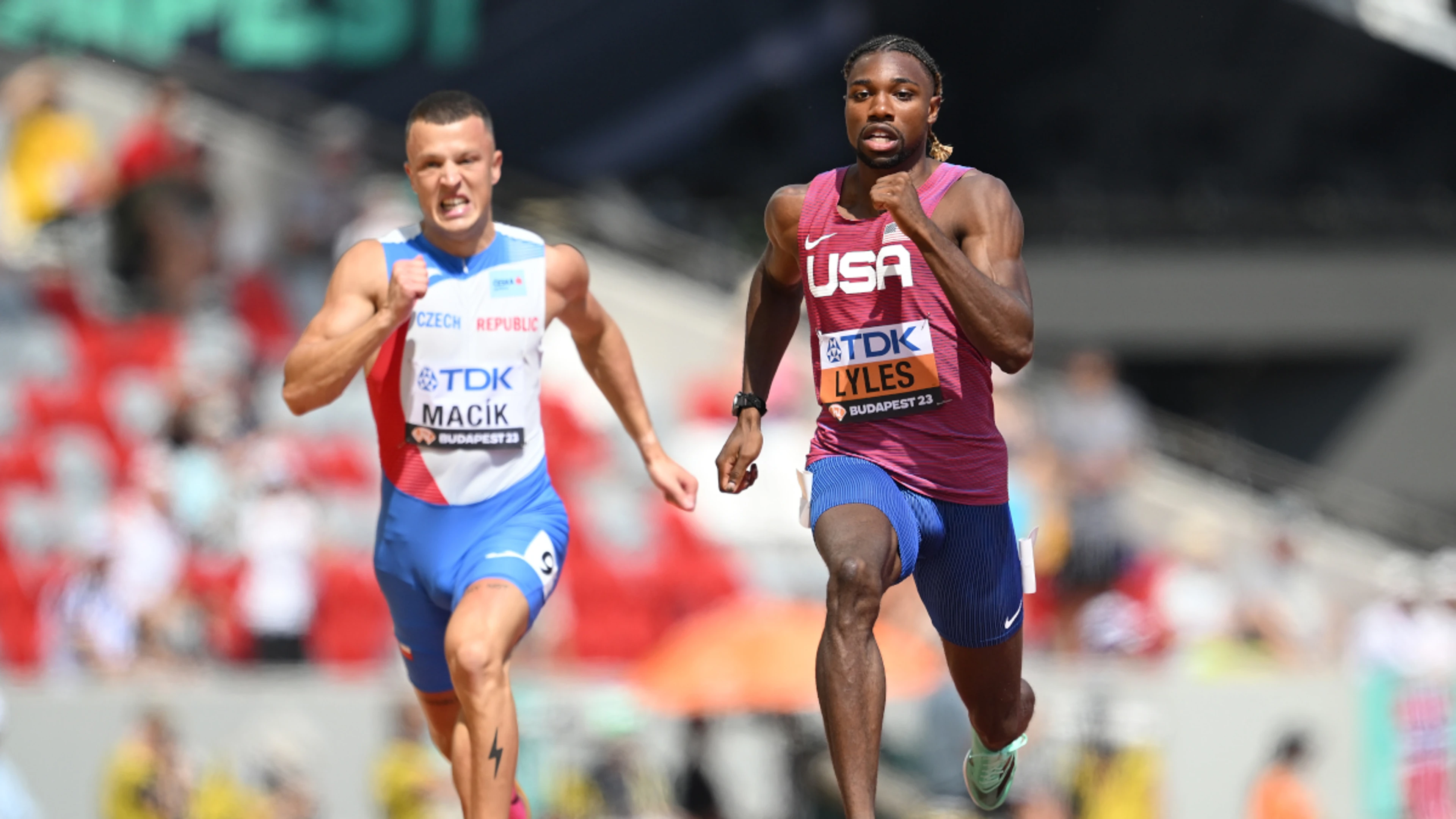 Lyles cruises into 200m semis in quest for sprint double