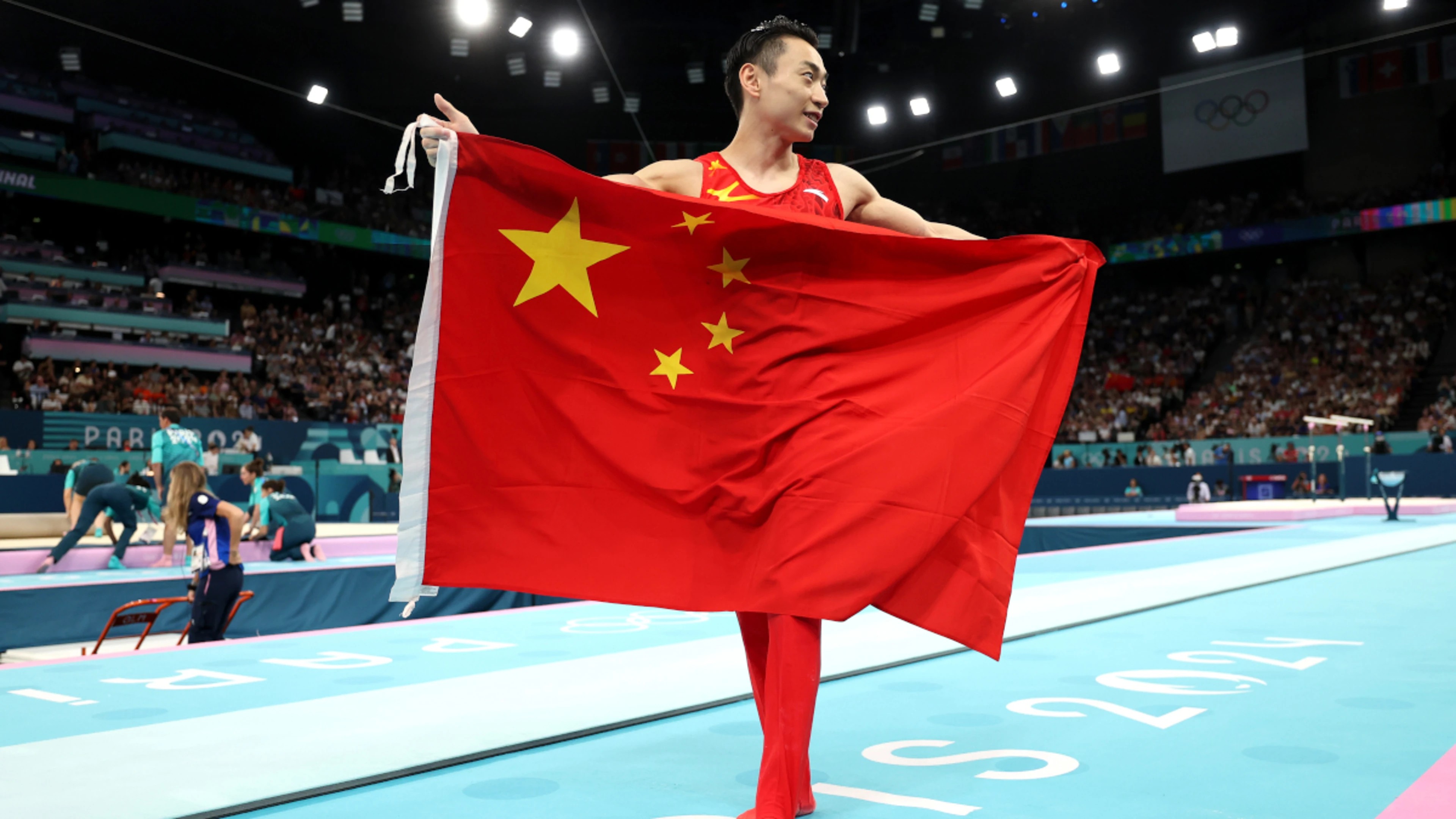 China's Zou Jingyuan defends Olympic men's parallel bars title
