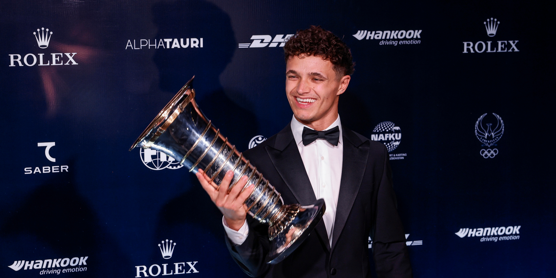 Norris gets his hands on F1 trophy as unwell Verstappen stays away