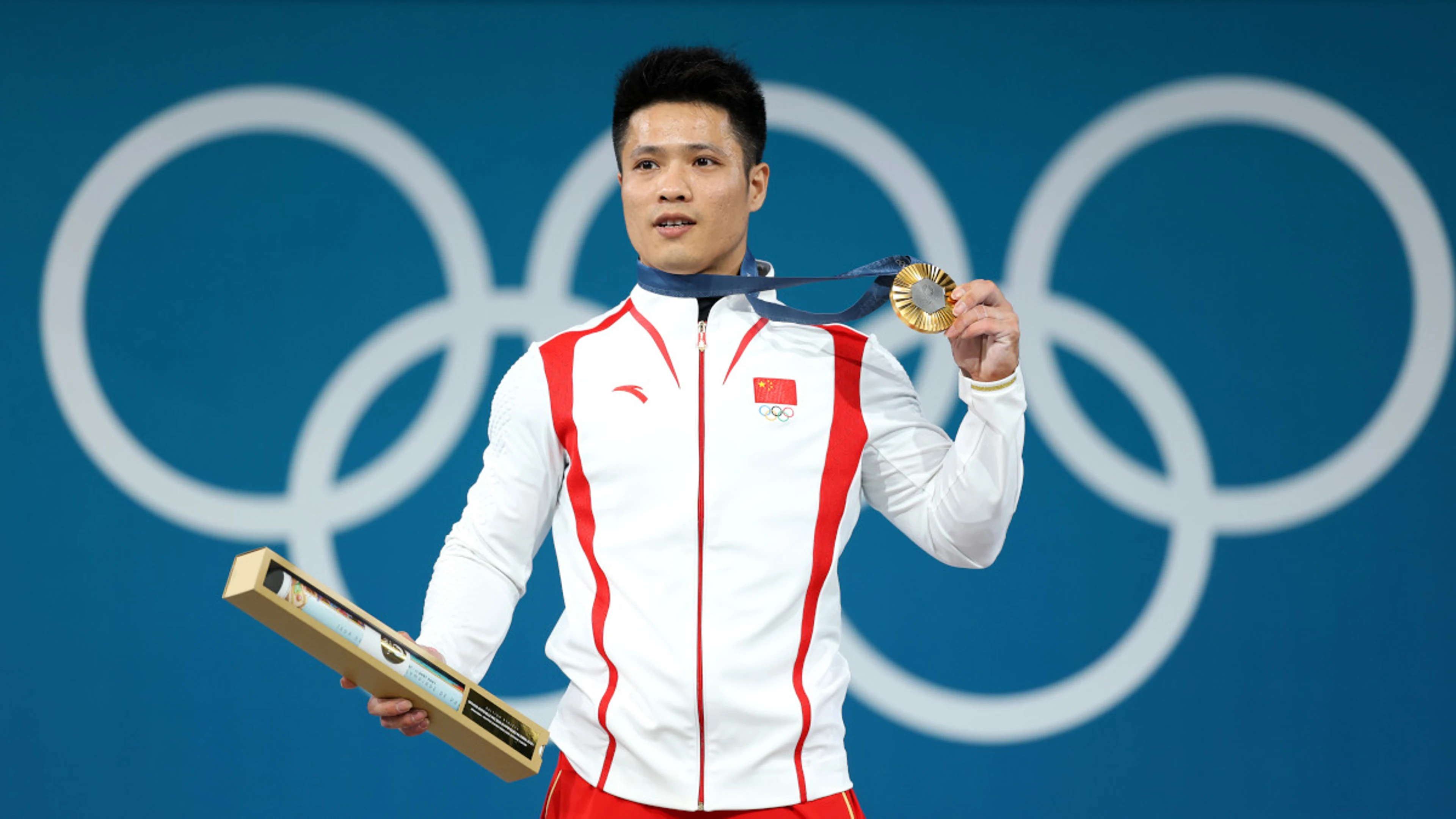 Dominant Li retains 61kg gold