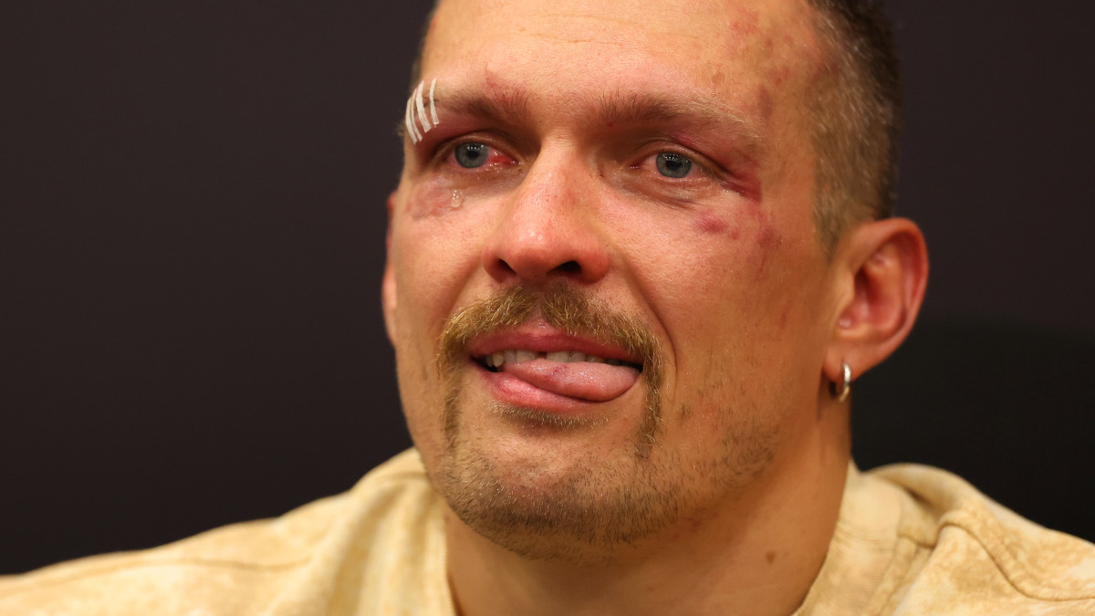Usyk in tears for late father after historic heavyweight win