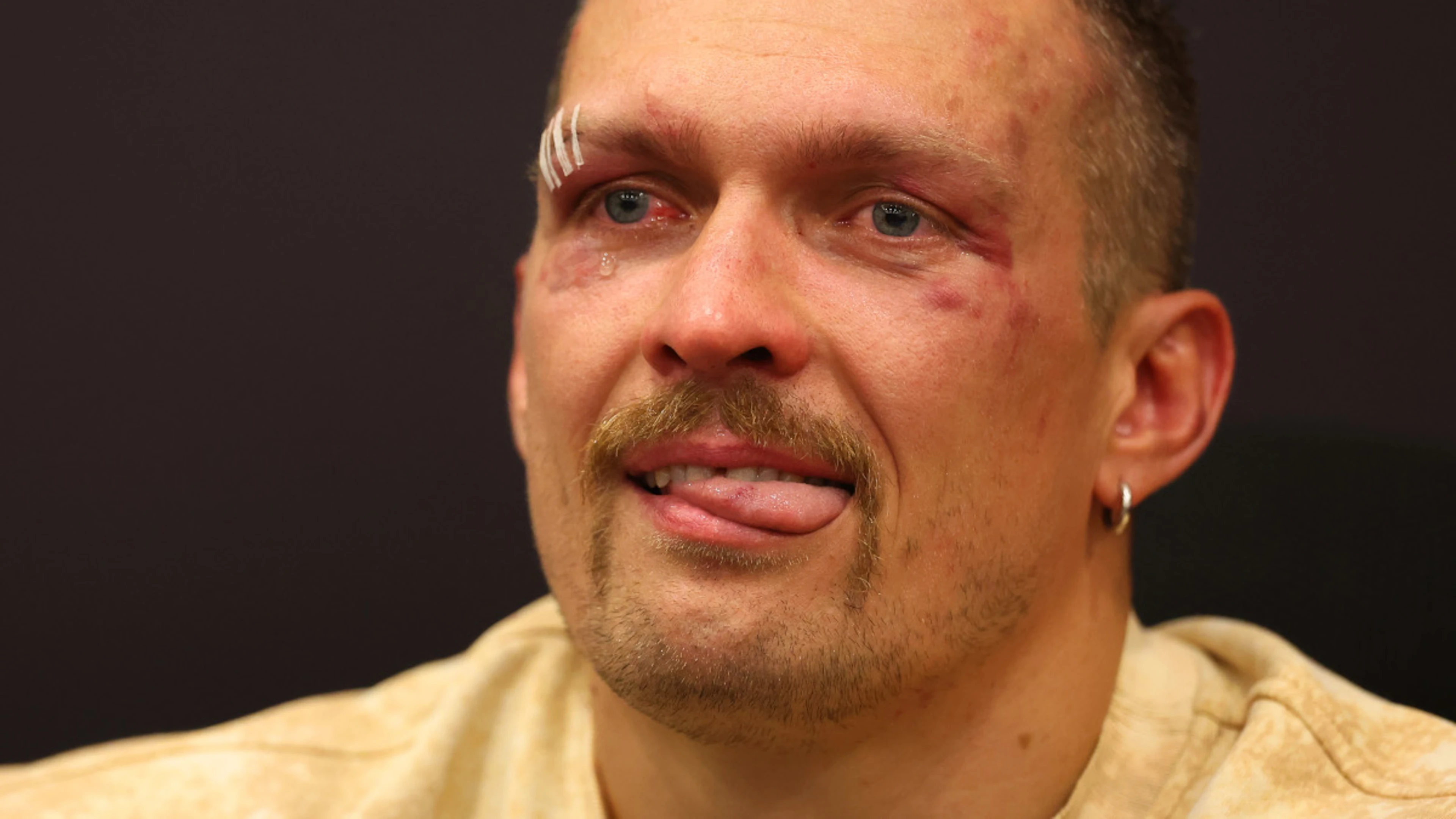 Usyk in tears for late father after historic heavyweight win